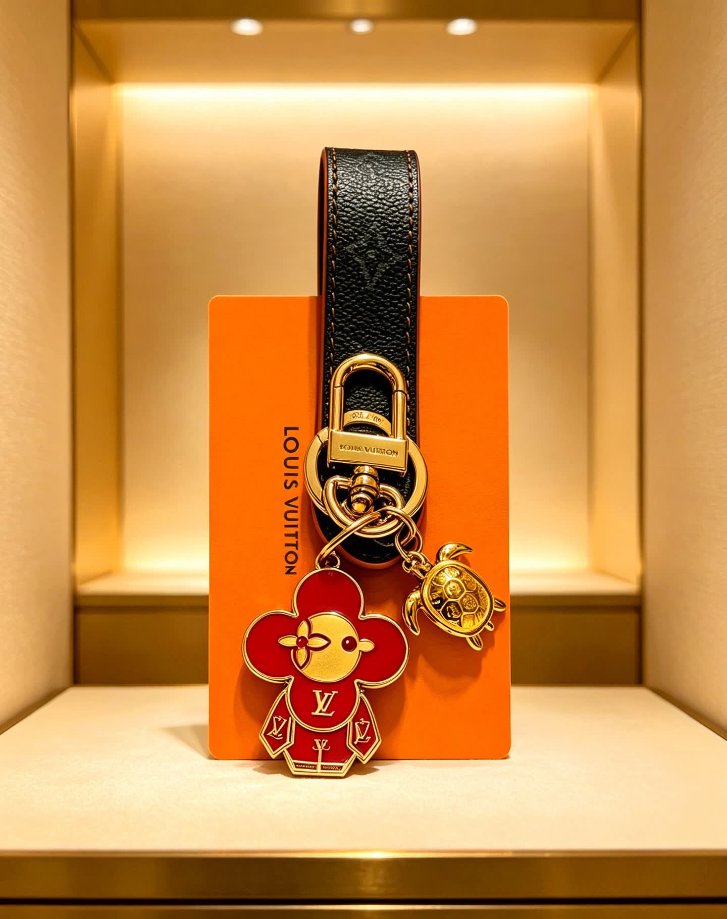 Louis Vuitton Leather Keychain with Flower and Turtle Charm Louis Vuitton Leather Keychain with Flower and Turtle Charm